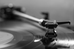 Picture of a turntable arm on a vinyl album